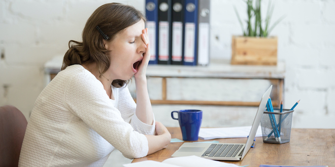 Sleepy young worker woman yawning Fatigue